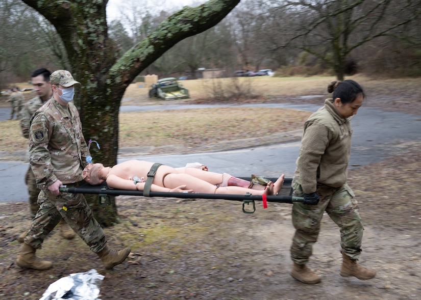 Members of the 316th Medical Group Ground Surgical Team carry a medical training mannikin to a simulated surgical operating room at Joint Base Andrews, Md., Jan. 25, 2024.