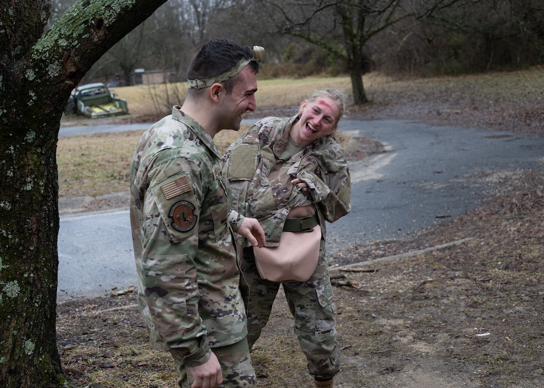 U.S. Air Force Capt. Dane O’Donnell, left, 316th Health Care Operations Squadron emergency services physician, comforts a simulated victim during live medical training at Joint Base Andrews, Md., Jan. 25, 2024.