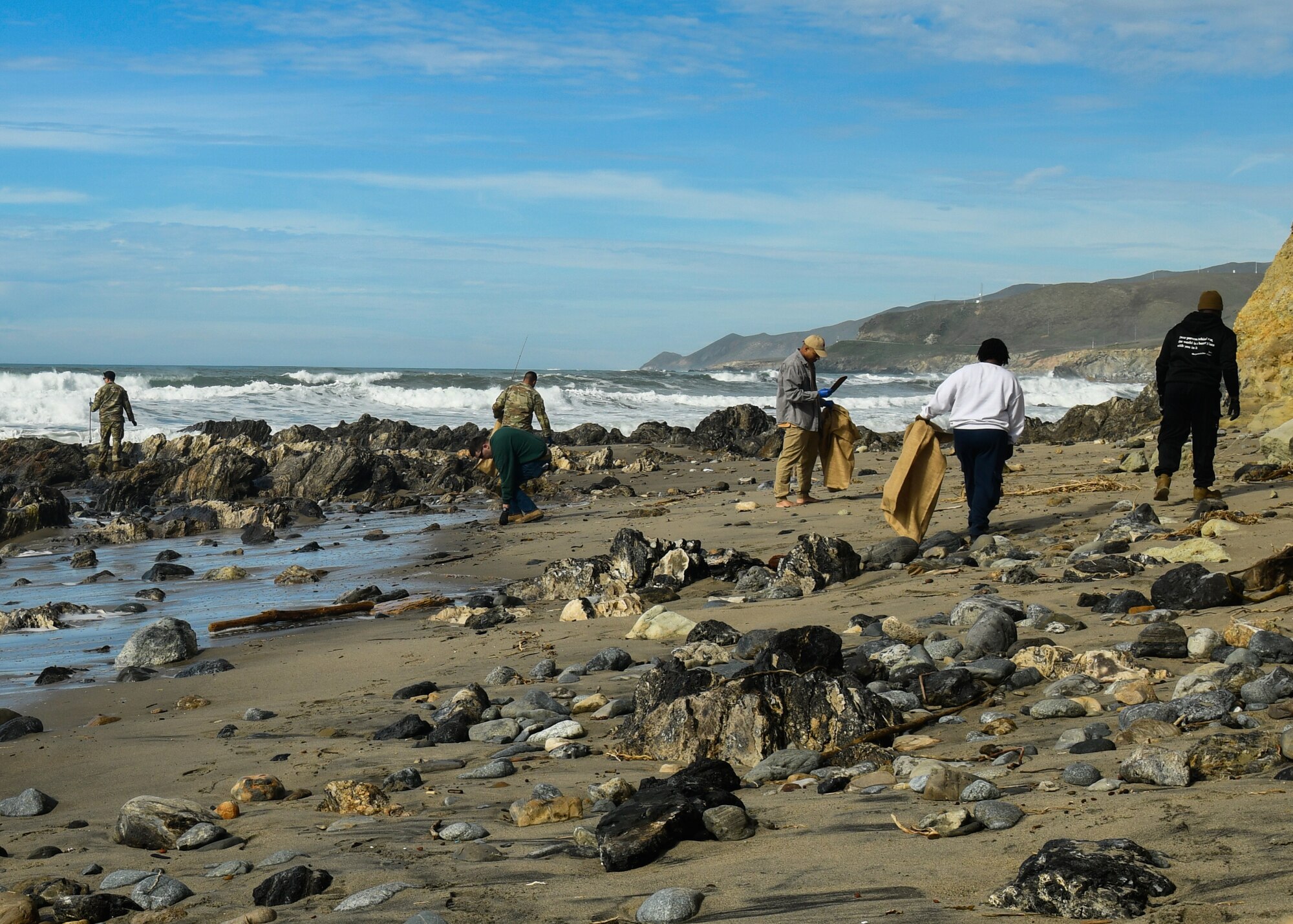 United States Space Force Guardians and U.S. Air Force Airmen conduct a cleanup of Minuteman Beach during a beach clean-up day at Vandenberg Space Force Base.