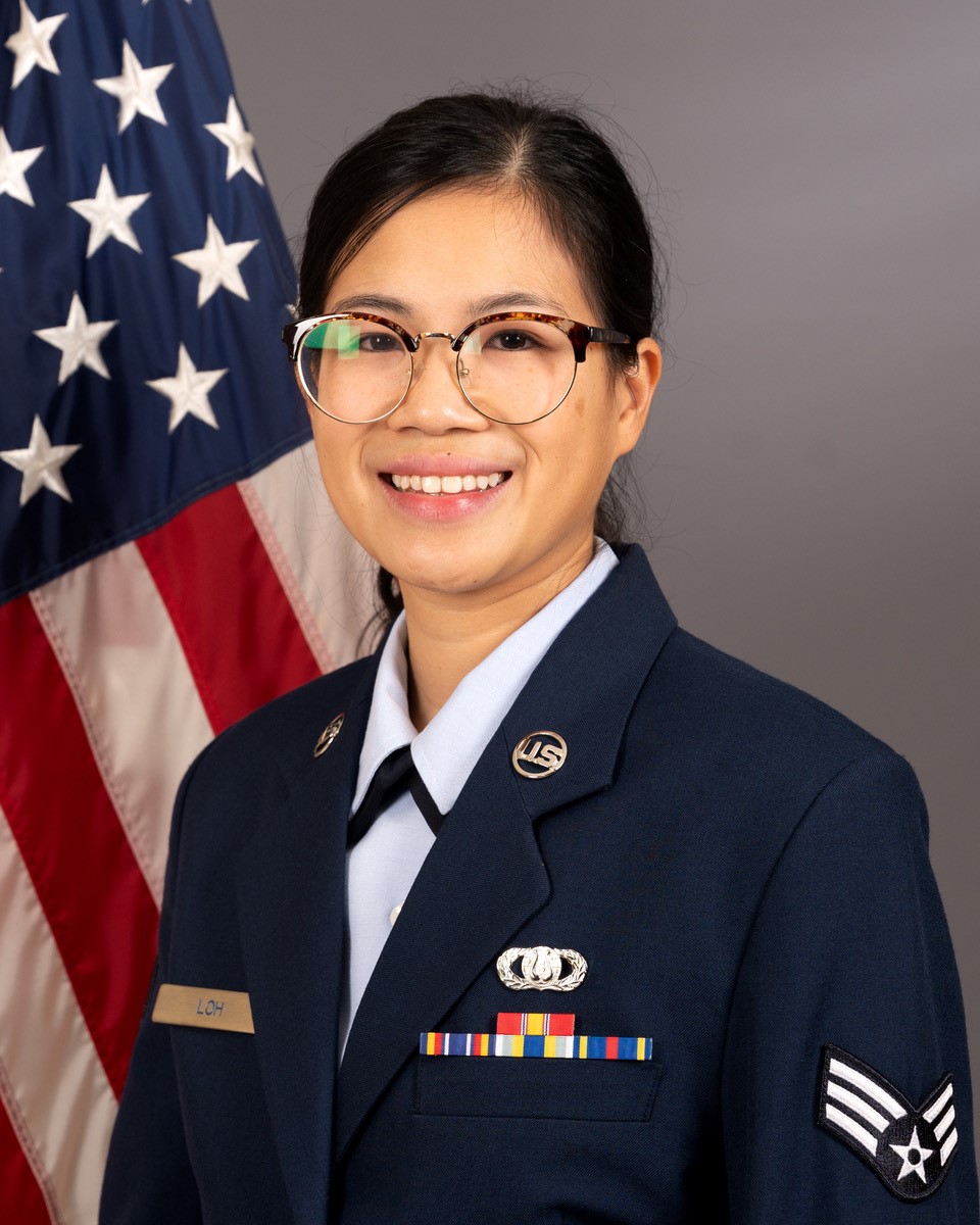 SrA Debra Loh official photo with American Flat behind right shoulder.