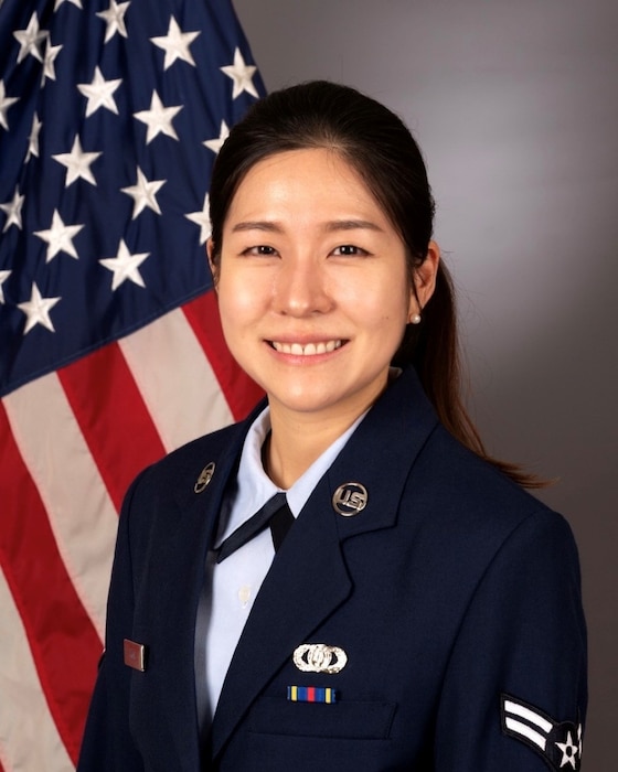 A1C Chloe Yoon official photo. American flag behind right shoulder.