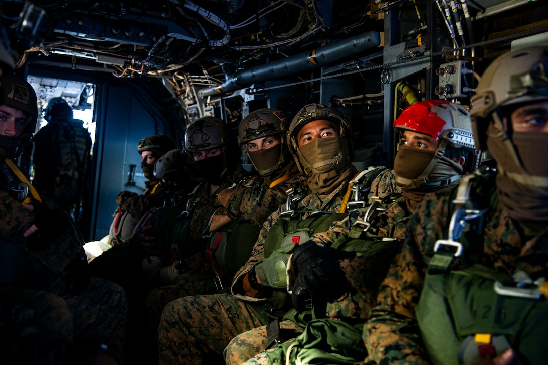 U.S. Marines with 3rd Radio Battalion listen to instruction during parachute operations.