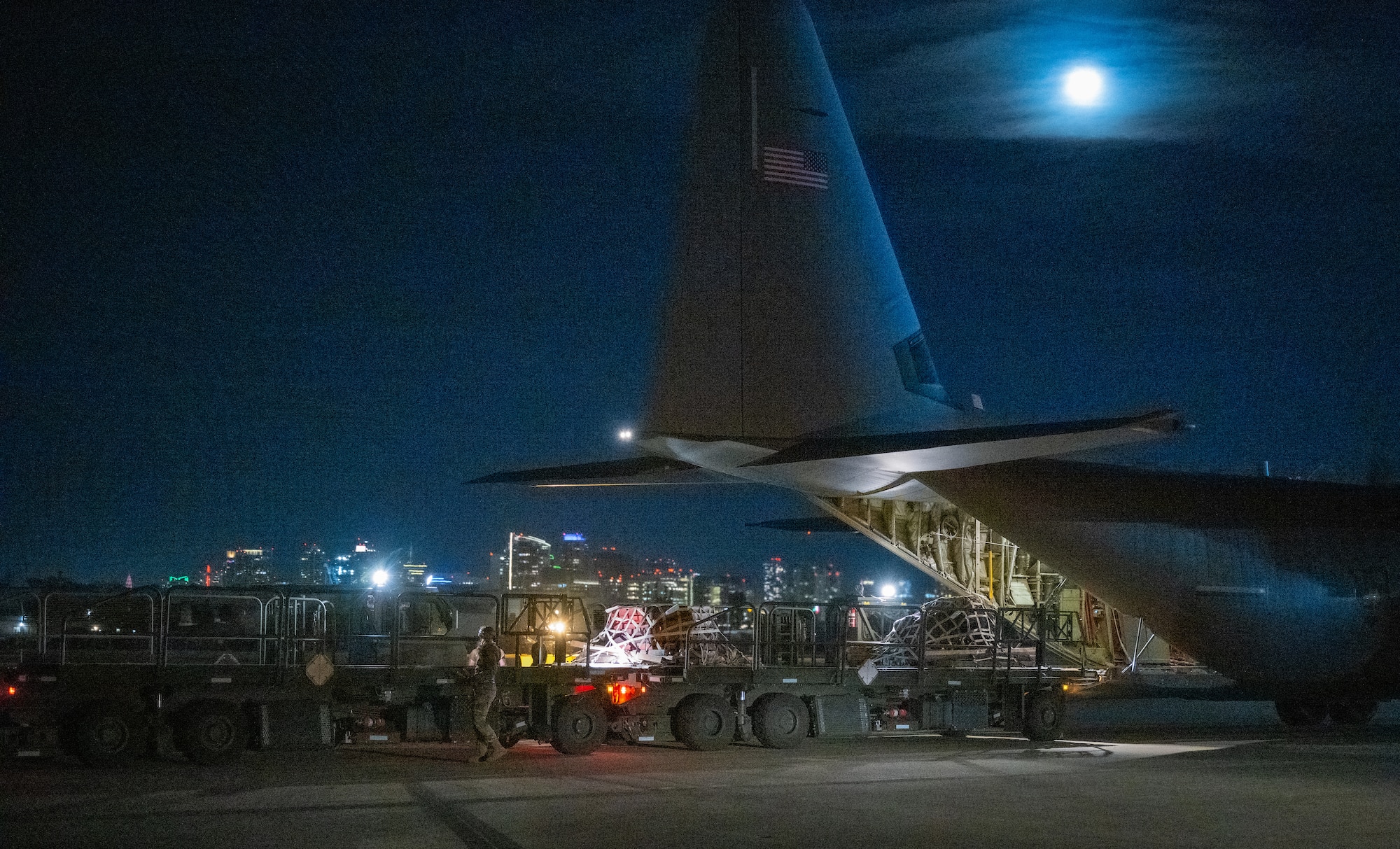 U.S. Air Force Senior Airman Alyssa Bradshaw, 732nd Expeditionary Air Mobility Squadron load team chief, deployed from Joint Base Elmendorf-Richardson, Alaska, directs cargo arrival from a C-130 Hercules during Exercise Bamboo Eagle 24-1 at Naval Air Station North Island, California, Jan. 26, 2024.