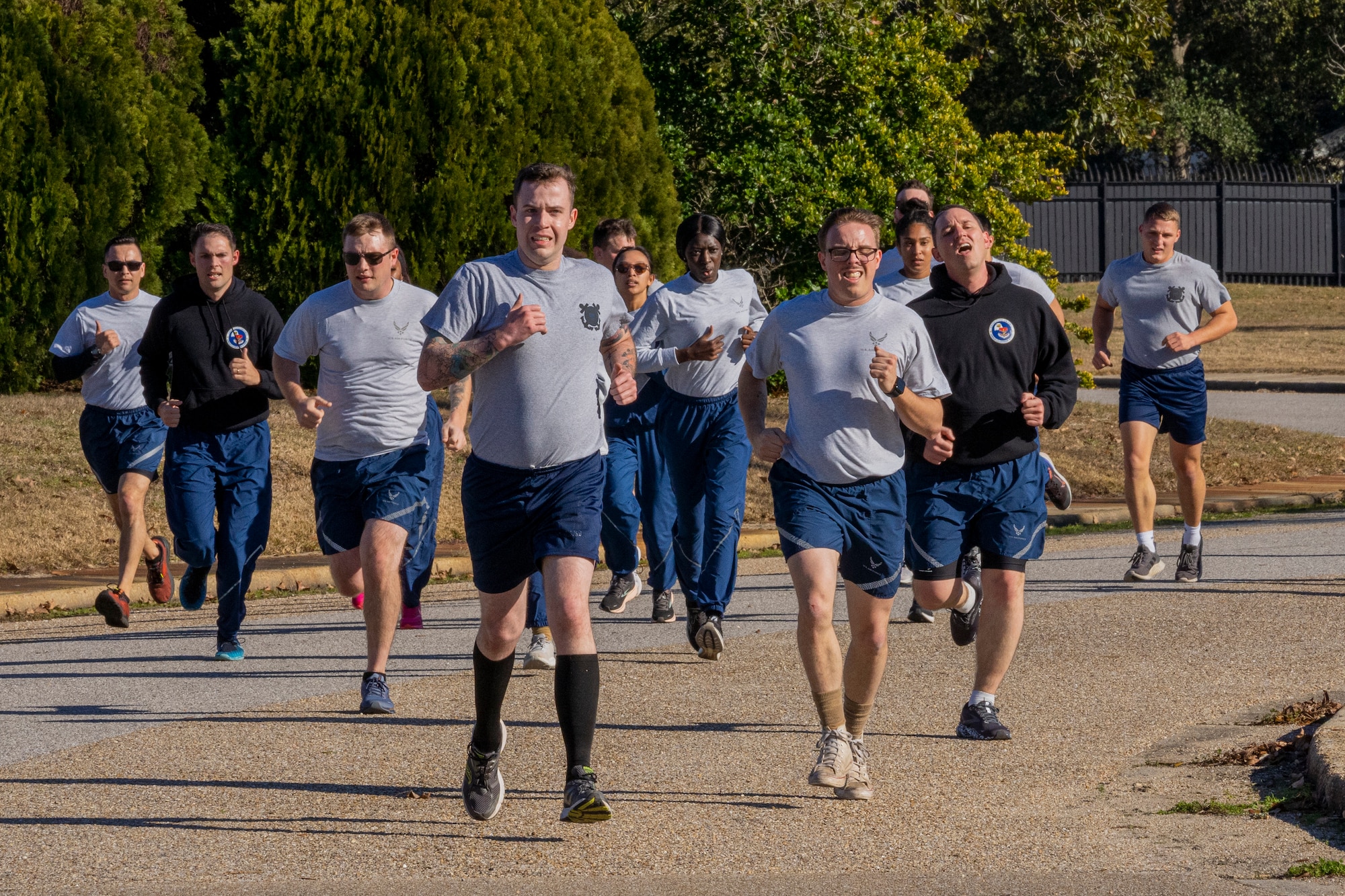 Students from Airman Leadership School sprint as a team during physical training at Keesler Air Force Base, Mississippi, Jan. 18, 2024.