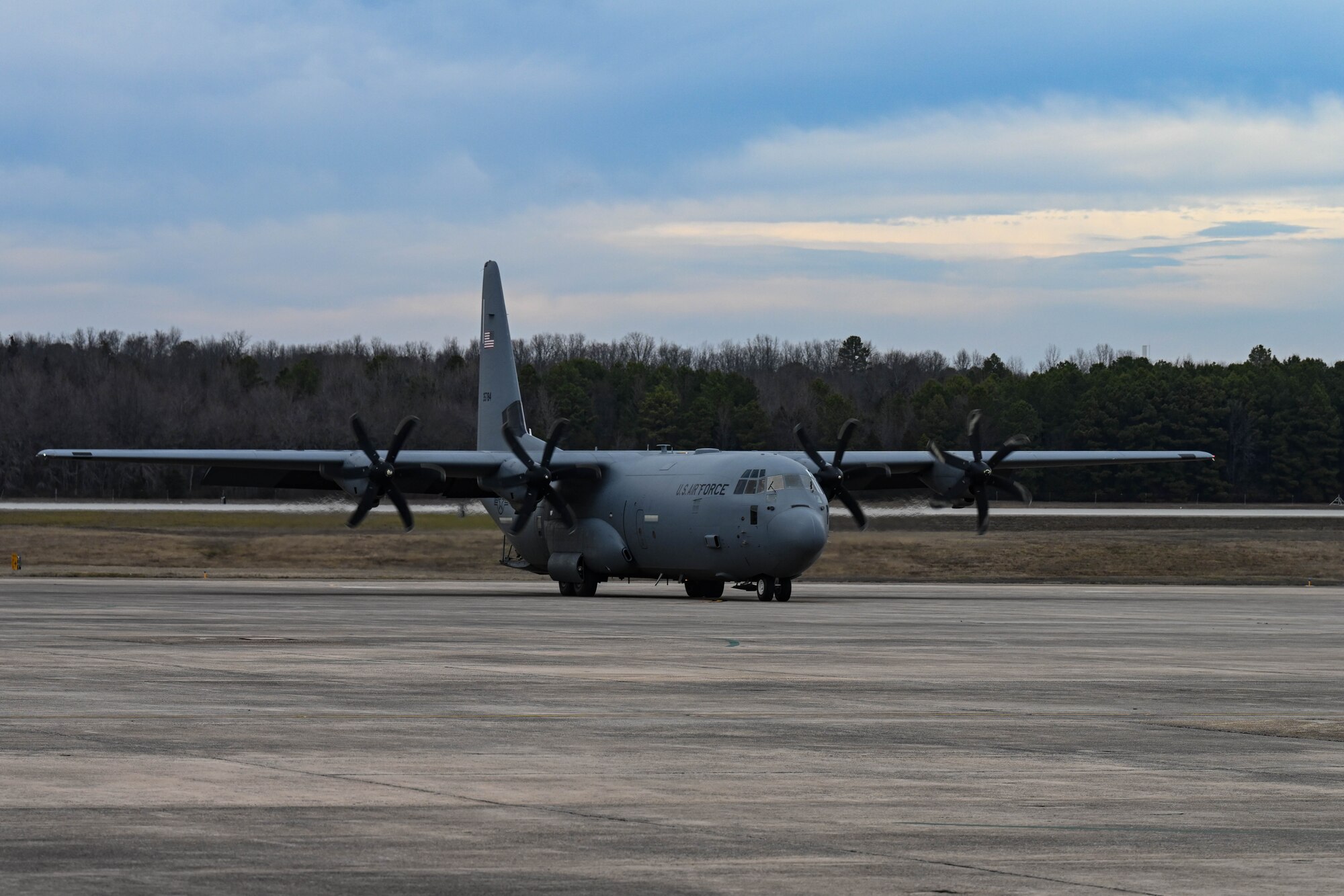 A C-130 taxis on the flightline.