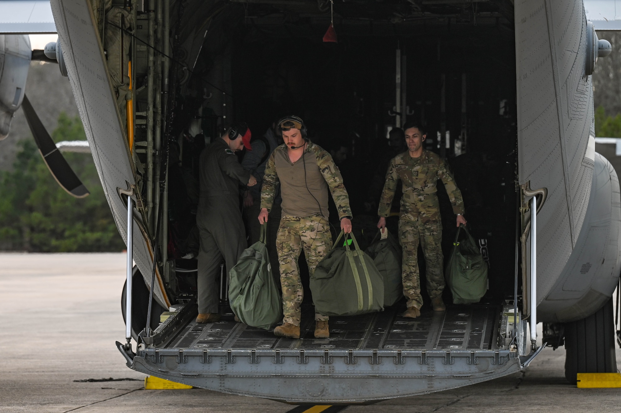 Airmen carry bags.
