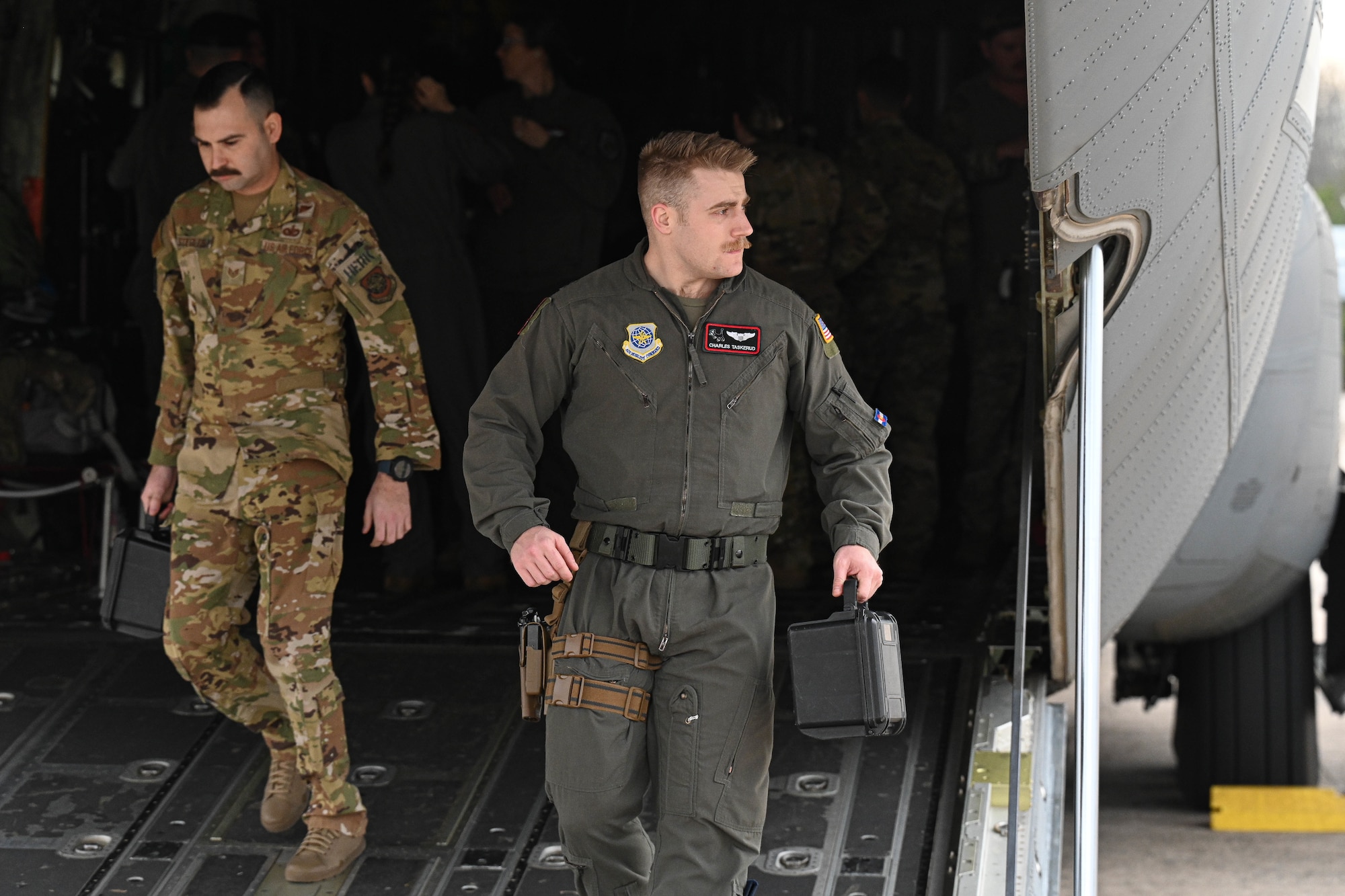 An Airman walks out of a C-130.