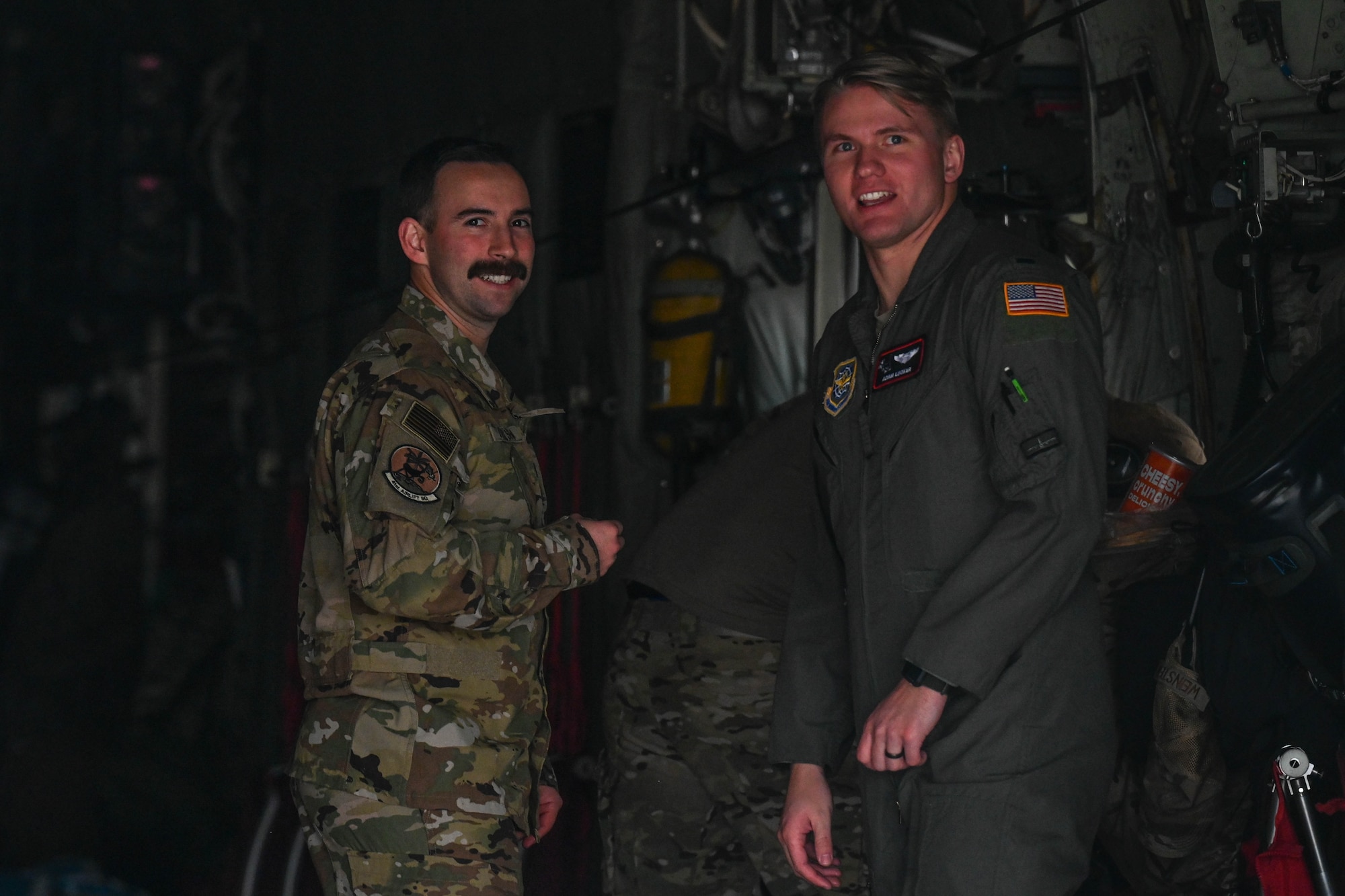 Two Airmen smile for a photo.