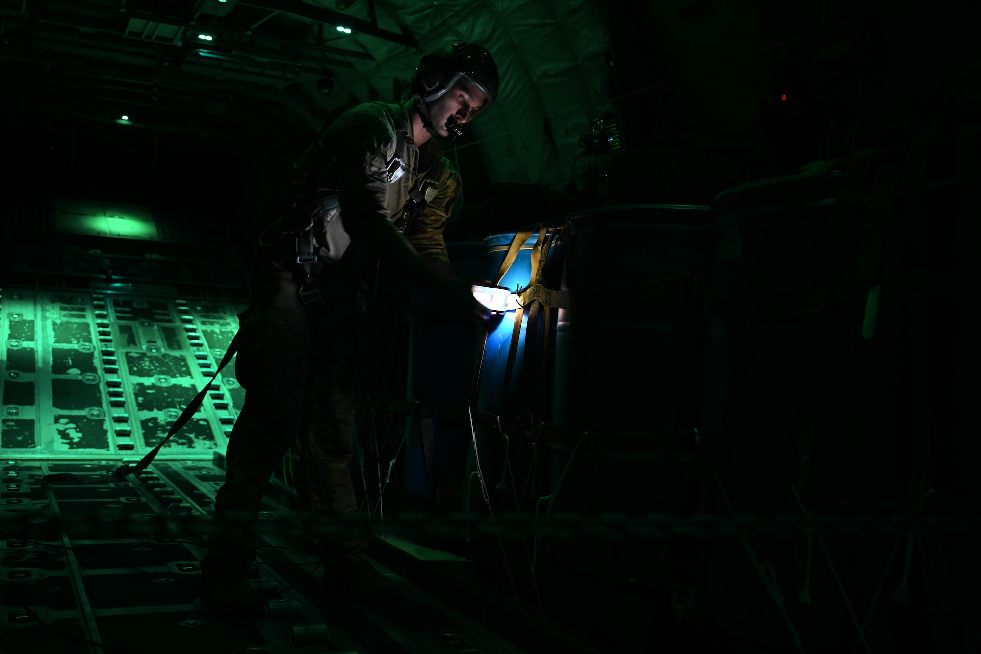 An Airman preps cargo for an airdrop.