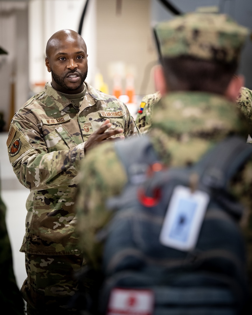 U.S. Air Force Master Sgt. Kevin Woodard, non-commissioned officer in charge of the Kentucky Air National Guard’s Fatality Search and Recovery Team, provides a mission brief to Ecuadorian military leaders at the Kentucky Air National Guard Base in Louisville, Ky., Jan. 31, 2024. The Ecuadorians are visiting this week to exchange information with the Kentucky National Guard as part of the State Partnership Program, a National Guard Bureau effort that pairs Guard units with foreign allies to foster enhanced understanding across all aspects of civil and military affairs. (U.S. Air National Guard photo by Dale Greer)