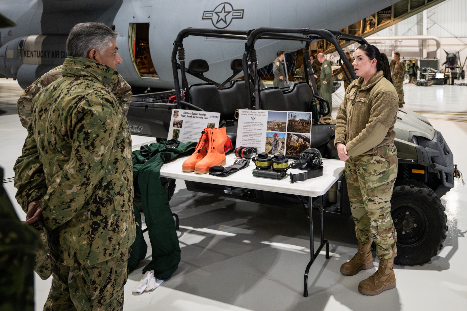 U.S. Air Force Senior Airman Carolyn Peabody, a member of the Kentucky Air National Guard’s Fatality Search and Recovery Team, provides a mission brief to Ecuadorian Navy Adm. Jaime Patricio Vela Erazo, chief of staff of the Ecuadorian military, at the Kentucky Air National Guard Base in Louisville, Ky., Jan. 31, 2024. Vela Erazo is one of several Ecuadorian military leaders visiting this week to exchange information with the Kentucky National Guard as part of the State Partnership Program, a National Guard Bureau effort that pairs Guard units with foreign allies to foster enhanced understanding across all aspects of civil and military affairs. (U.S. Air National Guard photo by Dale Greer)