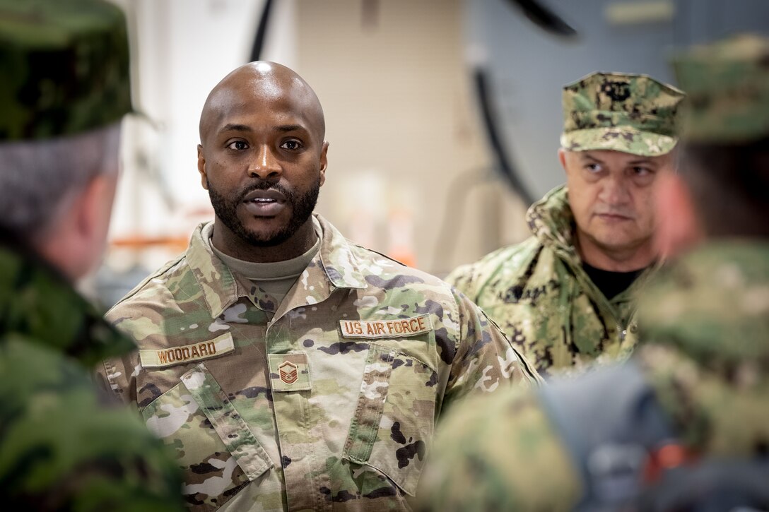 U.S. Air Force Master Sgt. Kevin Woodard, non-commissioned officer in charge of the Kentucky Air National Guard’s Fatality Search and Recovery Team, provides a mission brief to Ecuadorian military leaders at the Kentucky Air National Guard Base in Louisville, Ky., Jan. 31, 2024. The Ecuadorians are visiting this week to exchange information with the Kentucky National Guard as part of the State Partnership Program, a National Guard Bureau effort that pairs Guard units with foreign allies to foster enhanced understanding across all aspects of civil and military affairs. (U.S. Air National Guard photo by Dale Greer)