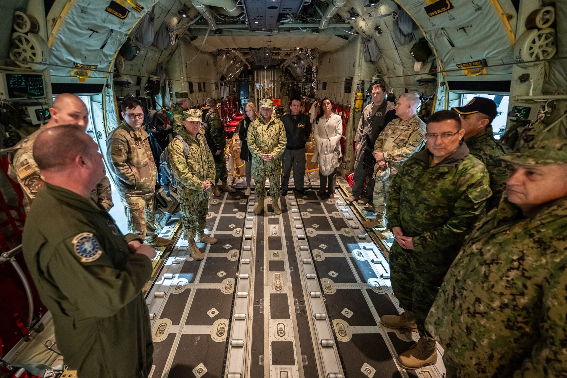 U.S. Air Force Senior Master Sgt. Collin King, left, a loadmaster assigned to the Kentucky Air National Guard’s 123rd Airlift Wing, briefs senior leaders from the Ecuadorian military on the capabilities of the unit’s new C-130J Super Hercules aircraft at the Kentucky Air National Guard Base in Louisville, Ky., Jan. 31, 2024. The Ecuadorians are visiting this week to exchange information with the Kentucky National Guard as part of the State Partnership Program, a National Guard Bureau effort that pairs Guard units with foreign allies to foster enhanced understanding across all aspects of civil and military affairs. (U.S. Air National Guard photo by Dale Greer)