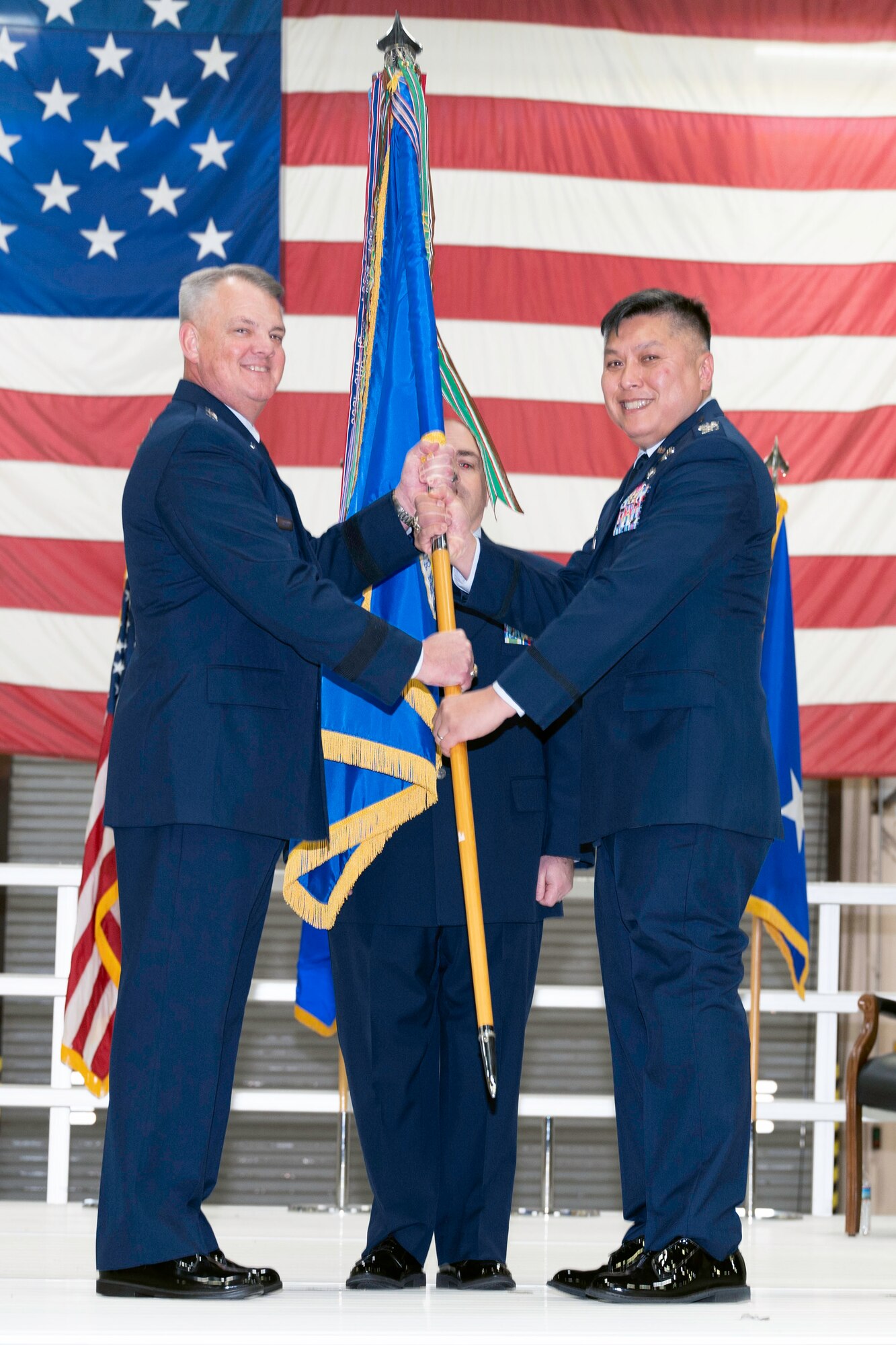 Maj. Gen. D. Scott Durham, Fourth Air Force commander passes the 434th Air Refueling Wing guidon to Col. Van Thai, incoming 434th Air Refueling Wing commander, during a ceremony.