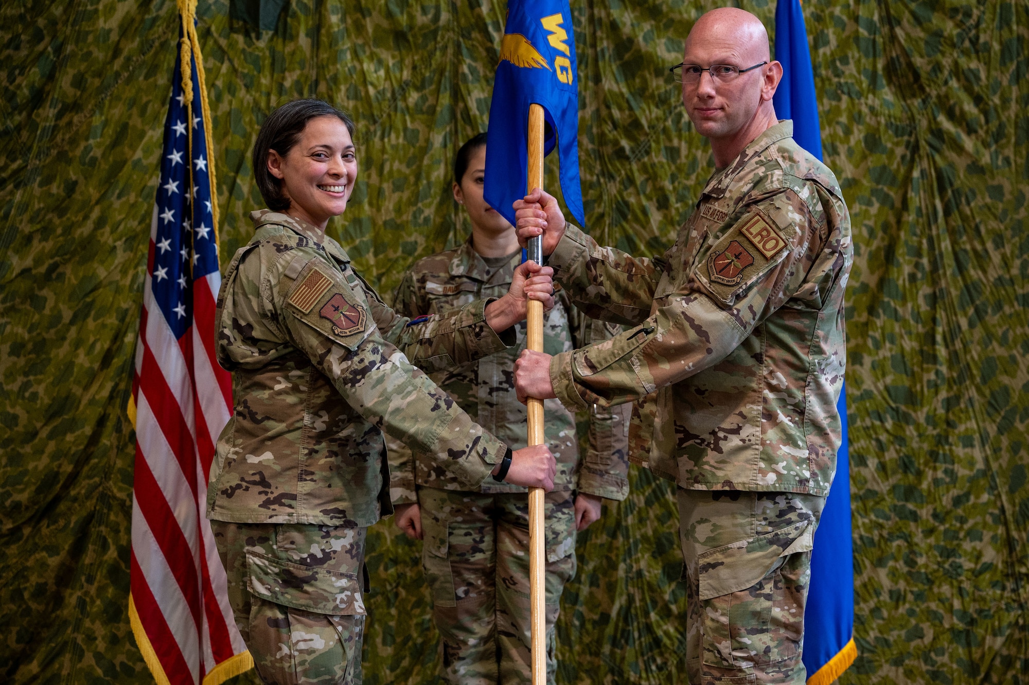 Lieutenant Colonel Breal and Major Bolton hold a guidon