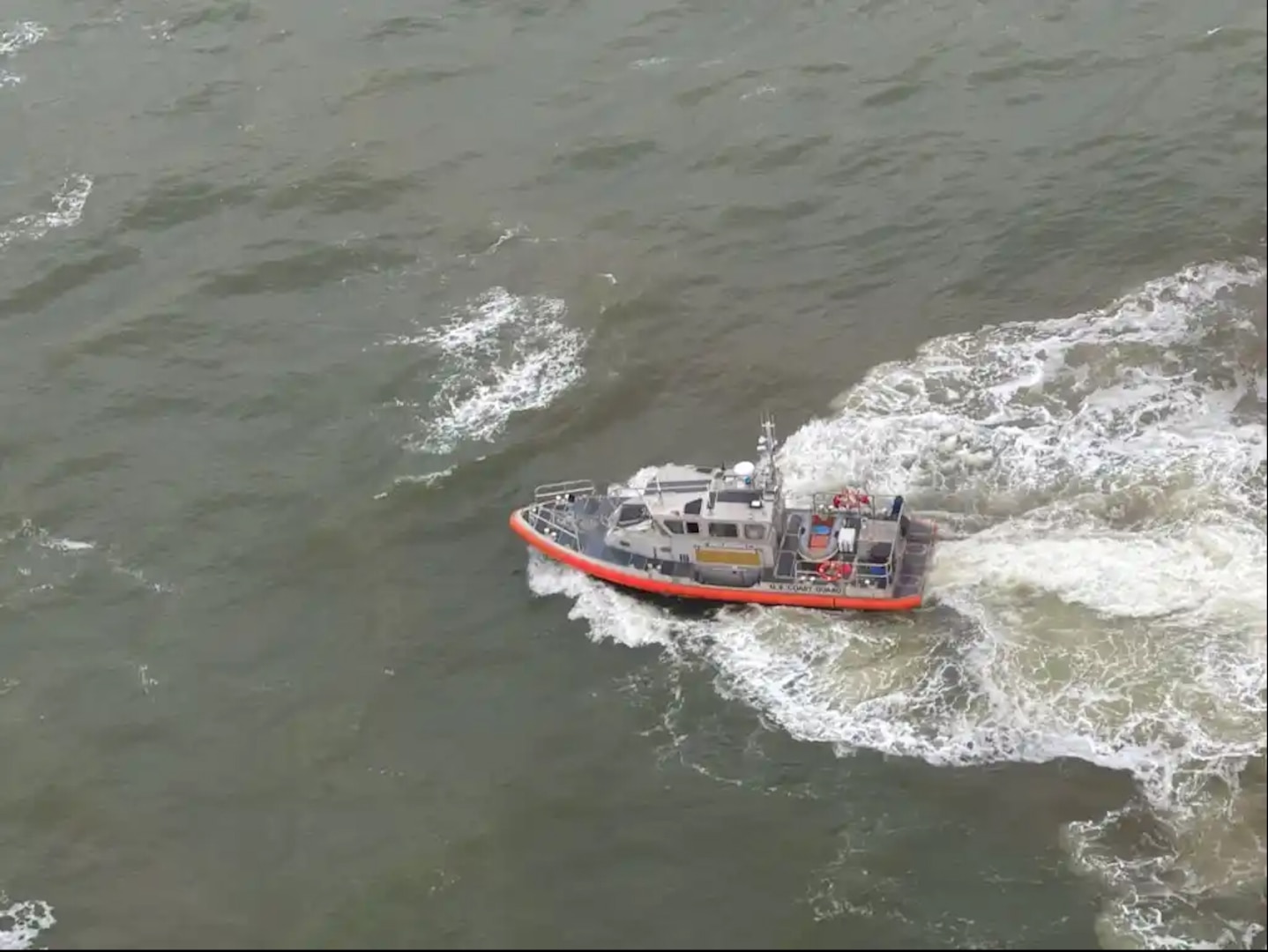 A Coast Guard Station Mayport boat crew rescues three people after their 26-foot sailboat sank near St. Marys Inlet, Georgia, Feb. 4, 2024.