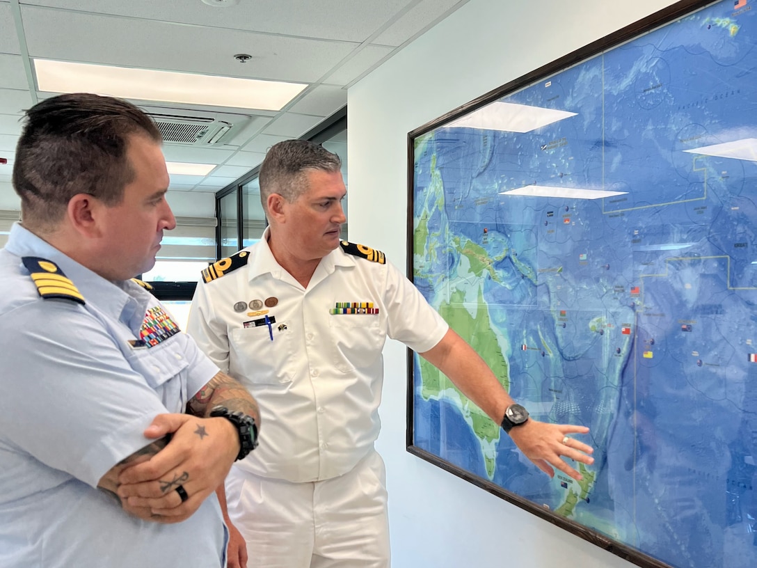 U.S. Coast Guard Forces Micronesia/Sector Guam’s Cmdr. Ryan Crose, response department head, and Lt. Cmdr. Lachlan Sommerville, the Royal Australian Navy’s maritime security advisor to the RMI Sea Patrol, discuss the regional during a visit on Jan. 26. 2024, in Majuro, Republic of the Marshall Islands. U.S. Coast Guard Forces Micronesia/Sector Guam personnel conducted a series of engagements in Majuro, Republic of the Marshall Islands (RMI), from Jan. 24-29, 2024. (U.S. Coast Guard photo)
