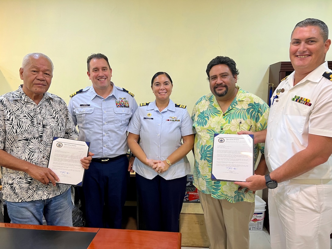 In Majuro, Republic of the Marshall Islands, on Jan. 26, 2024, U.S. Coast Guard Forces Micronesia/Sector Guam’s Cmdr. Ryan Crose, response department head, and Lt. Cmdr. Christine Igisomar, COFA maritime advisor, officially presented Marshall Islands Police Commissioner George Lanwi and Lt. Cmdr. Lachlan Sommerville, the Royal Australian Navy’s Maritime Security Advisor to the RMI Sea Patrol, with invitations for the inaugural Patrol Boat Round Up in Guam to be held summer 2024. This visit marks a continuation of efforts to enhance the U.S. Coast Guard's positive relationship with the Marshall Islands, particularly its maritime law enforcement entity, the RMI Sea Patrol. (U.S. Coast Guard photo)