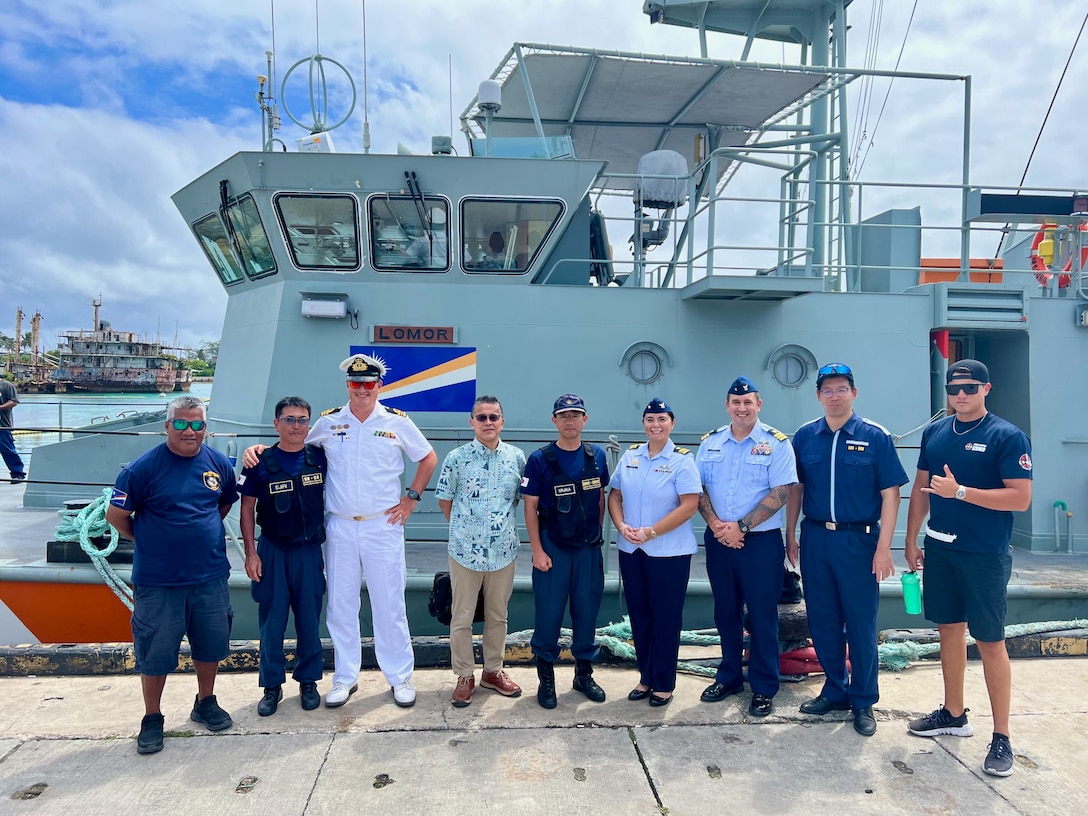 In Majuro, Republic of the Marshall Islands, on Jan. 26, 2024, U.S. Coast Guard Forces Micronesia/Sector Guam's Cmdr. Ryan Crose, response department head, and Lt. Cmdr. Christine Igisomar, COFA maritime advisor, stand for a photo with Lt. Cmdr. Lachlan Sommerville, the Royal Australian Navy's Maritime Security Advisor to the RMI Sea Patrol, and members of the RMI Sea Patrol. This visit marks a continuation of efforts to enhance the U.S. Coast Guard's positive relationship with the Marshall Islands, particularly its maritime law enforcement entity, the RMI Sea Patrol. (U.S. Coast Guard photo)