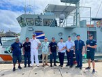 In Majuro, Republic of the Marshall Islands, on Jan. 26, 2024, U.S. Coast Guard Forces Micronesia/Sector Guam's Cmdr. Ryan Crose, response department head, and Lt. Cmdr. Christine Igisomar, COFA maritime advisor, stand for a photo with Lt. Cmdr. Lachlan Sommerville, the Royal Australian Navy's Maritime Security Advisor to the RMI Sea Patrol, and members of the RMI Sea Patrol. This visit marks a continuation of efforts to enhance the U.S. Coast Guard's positive relationship with the Marshall Islands, particularly its maritime law enforcement entity, the RMI Sea Patrol. (U.S. Coast Guard photo)