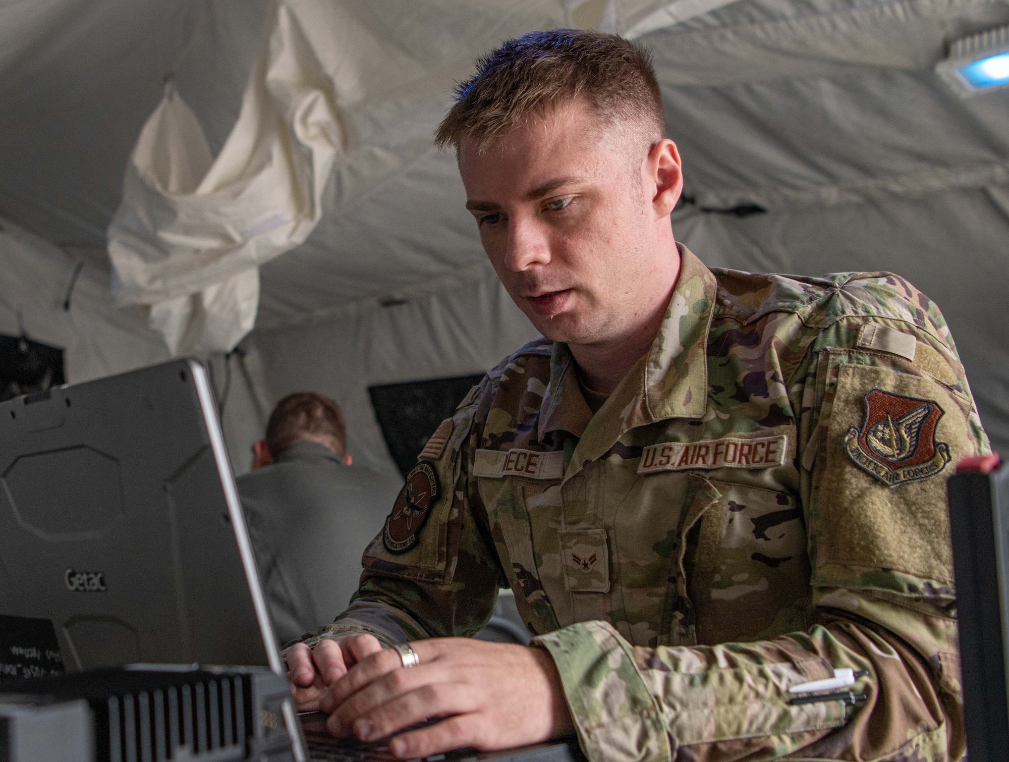 An Airman uses a mobile computer.