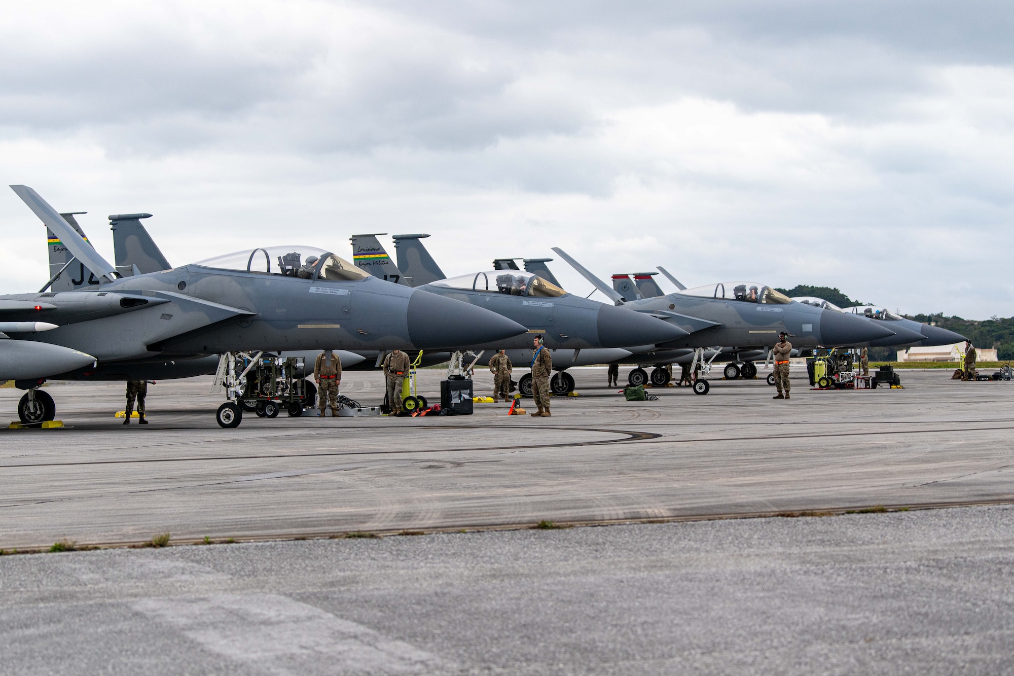 Five F-15C Eagles sit stationary side by side.