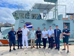 In Majuro, Republic of the Marshall Islands, on Jan. 26, 2024, U.S. Coast Guard Forces Micronesia/Sector Guam's Cmdr. Ryan Crose, response department head, and Lt. Cmdr. Christine Igisomar, COFA maritime advisor, stand for a photo with Lt. Cmdr. Lachlan Sommerville, the Royal Australian Navy's Maritime Security Advisor to the RMI Sea Patrol, and members of the RMI Sea Patrol. This visit marks a continuation of efforts to enhance the U.S. Coast Guard's positive relationship with the Marshall Islands, particularly its maritime law enforcement entity, the RMI Sea Patrol. (U.S. Coast Guard photo)