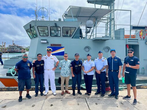 In Majuro, Republic of the Marshall Islands, on Jan. 26, 2024, U.S. Coast Guard Forces Micronesia/Sector Guam's Cmdr. Ryan Crose, response department head, and Lt. Cmdr. Christine Igisomar, COFA maritime advisor, stand for a photo with Lt. Cmdr. Lachlan Sommerville, the Royal Australian Navy's Maritime Security Advisor to the RMI Sea Patrol, and members of the RMI Sea Patrol. This visit marks a continuation of efforts to enhance the U.S. Coast Guard's positive relationship with the Marshall Islands, particularly its maritime law enforcement entity, the RMI Sea Patrol. (U.S. Coast Guard photo)