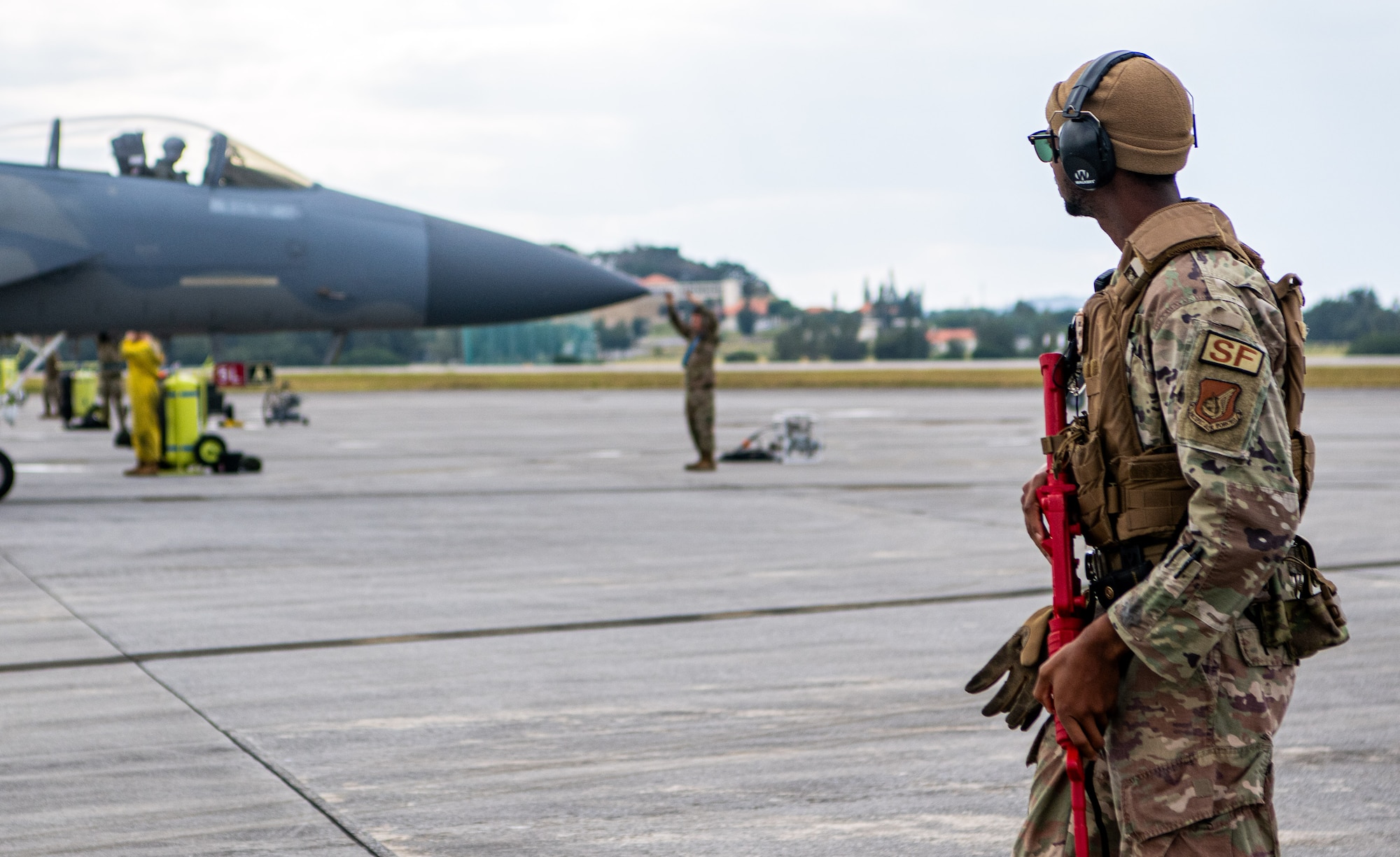 A Security Forces Airman patrols F-15C Eagles.