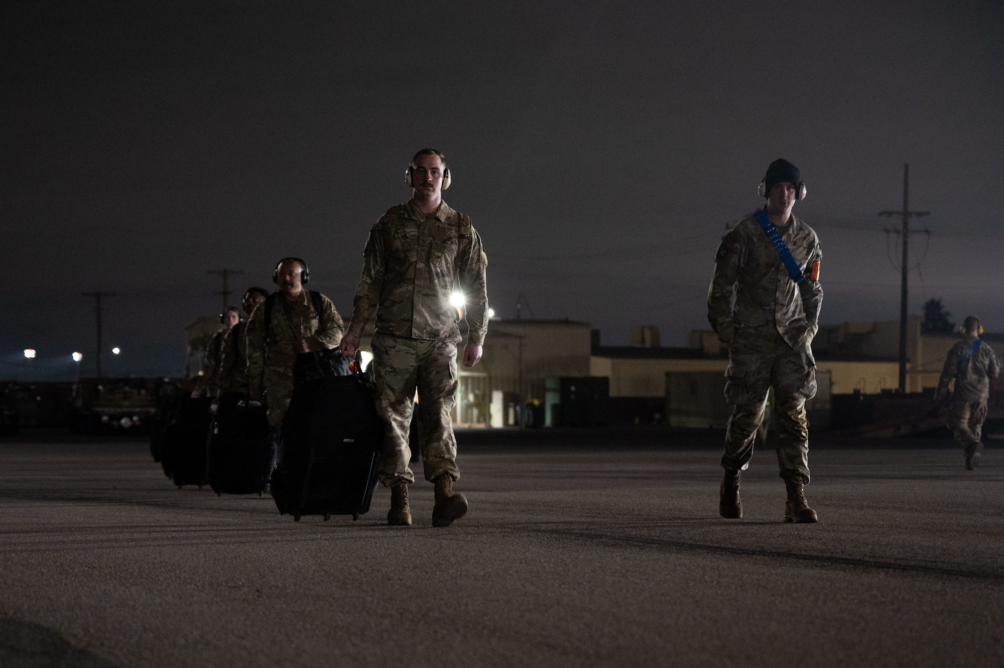 Airmen assigned to the 515th Air Mobility Squadron prepare to board a C-130J Super Hercules before its departure to Naval Air Station North Island at Nellis Air Force Base, Nevada, Jan. 25, 2024.