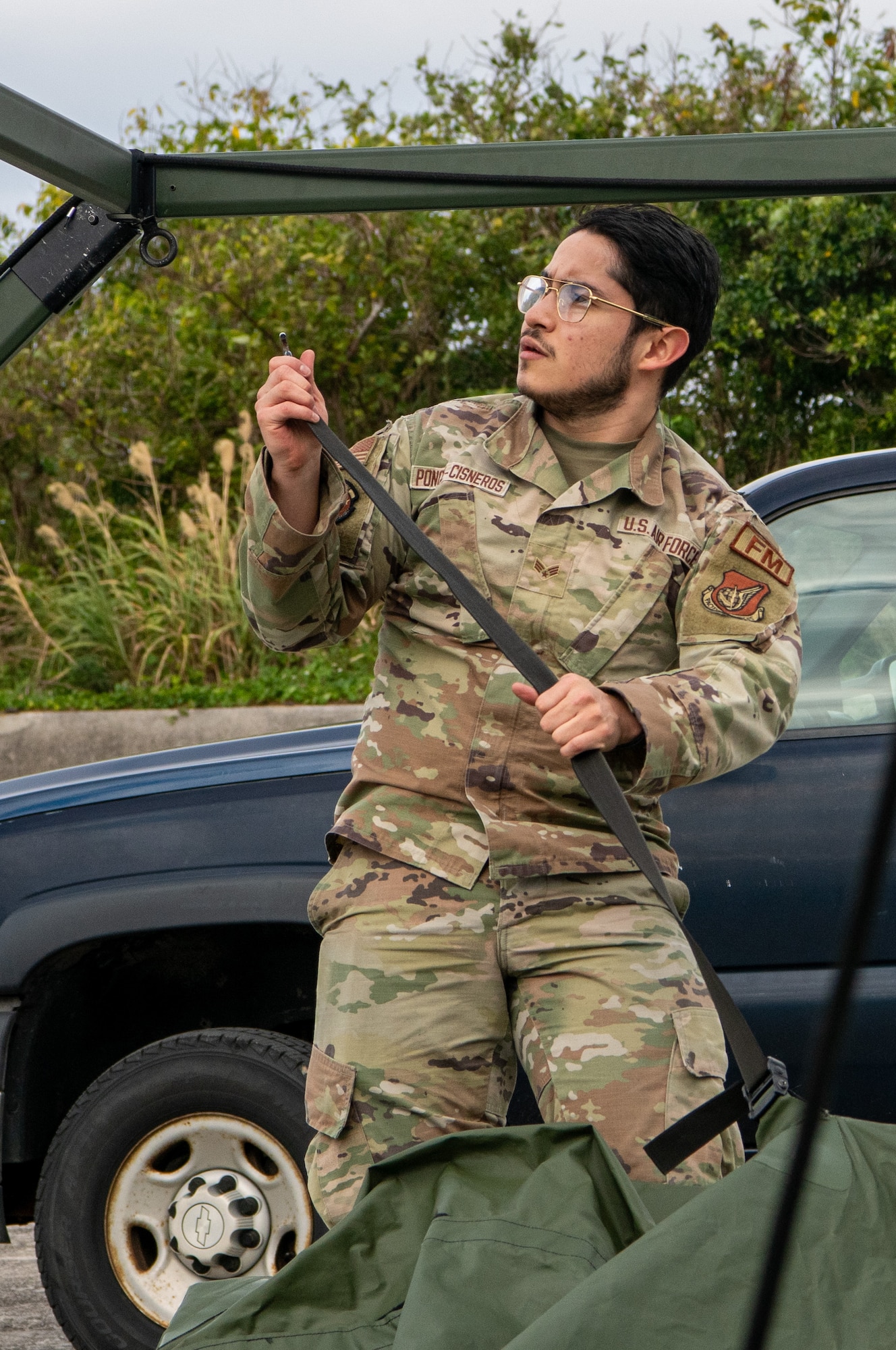 An Airman pitches a tent.