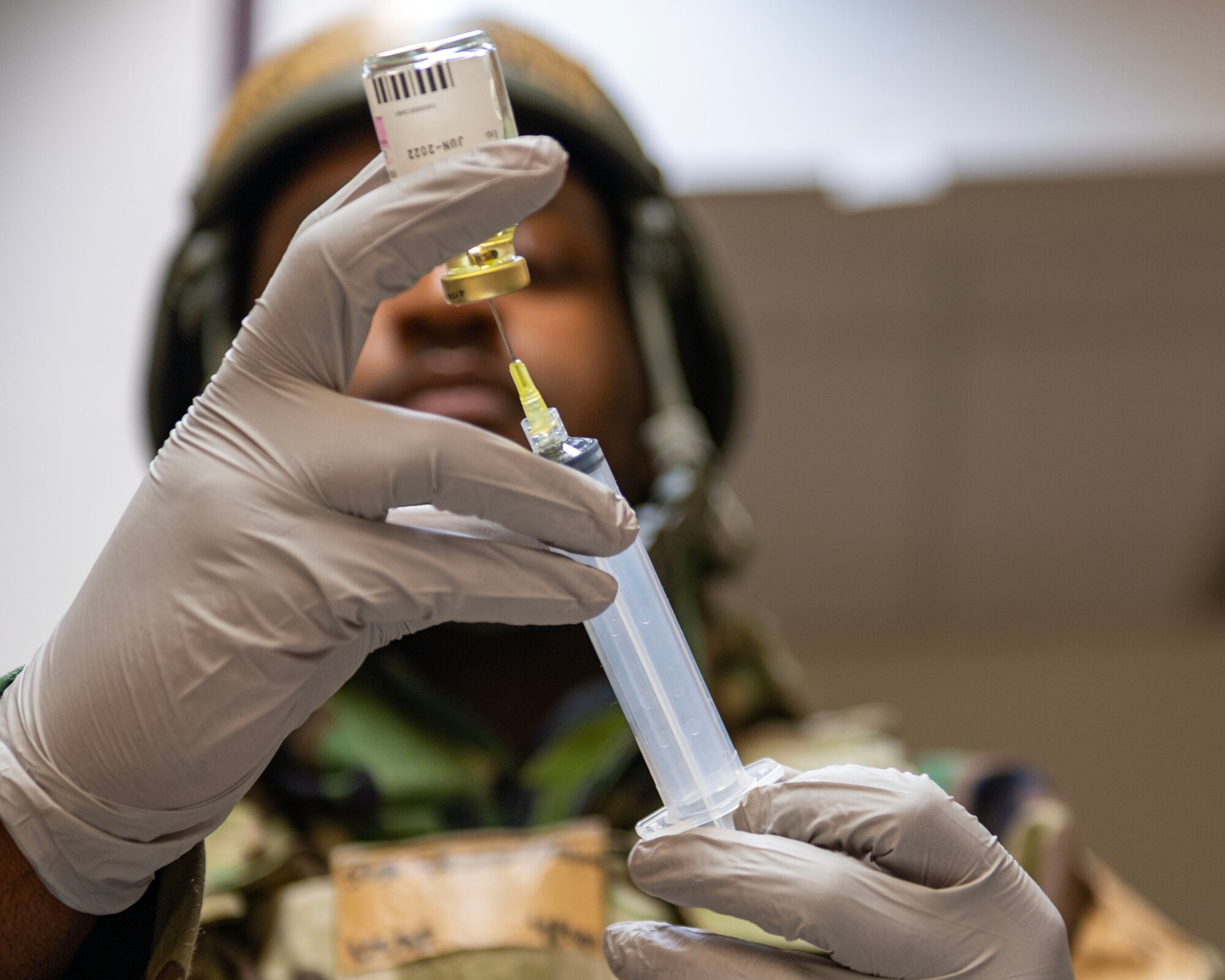 A U.S. Air Force Staff Sgt. Quashon Skinner, 51st Operational Medical Readiness Squadron pharmacy non-commissioned officer in charge, prepares an injection in a mass casualty training event during Beverly Midnight 24-1 at Osan Air Base, Republic of Korea, Feb. 1, 2024. Medical education and training ensures all 51st Medical Group Airmen are equipped with fundamental, life saving clinical skills. BM24-1 is a routine training event that tests the military capabilities across the peninsula, allowing combined and joint training at both the operational and tactical levels. (U.S. Air Force photo by Staff Sgt. Aubree Owens)