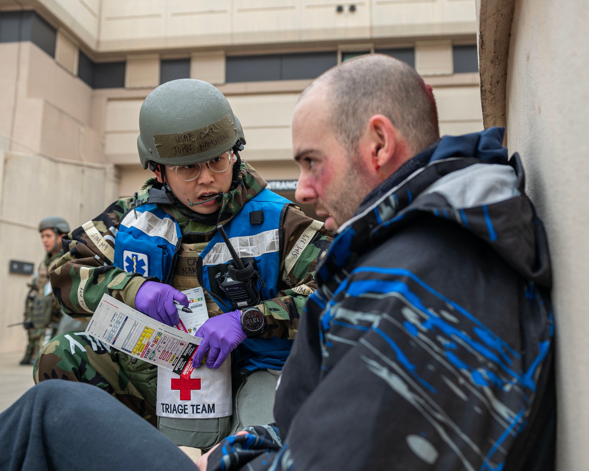 U.S. Air Force Capt. John Namgoong, 51st Medical Group triage officer, speaks to a simulated triage patient in a mass casualty training event during Beverly Midnight 24-1 at Osan Air Base, Republic of Korea, Feb. 1, 2024. The 51st MDG medics prepare daily for any contingencies if and when they occur, with the foremost priority being ready to fight tonight. BM24-1 is a routine training event that tests the military capabilities across the peninsula, allowing combined and joint training at both the operational and tactical levels. (U.S. Air Force photo by Staff Sgt. Aubree Owens)