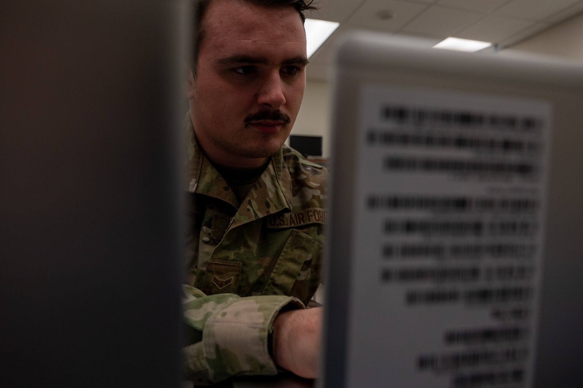 Airman 1st Class Kenzer Lebret installs programs on new computers for the 8th Fighter Wing.