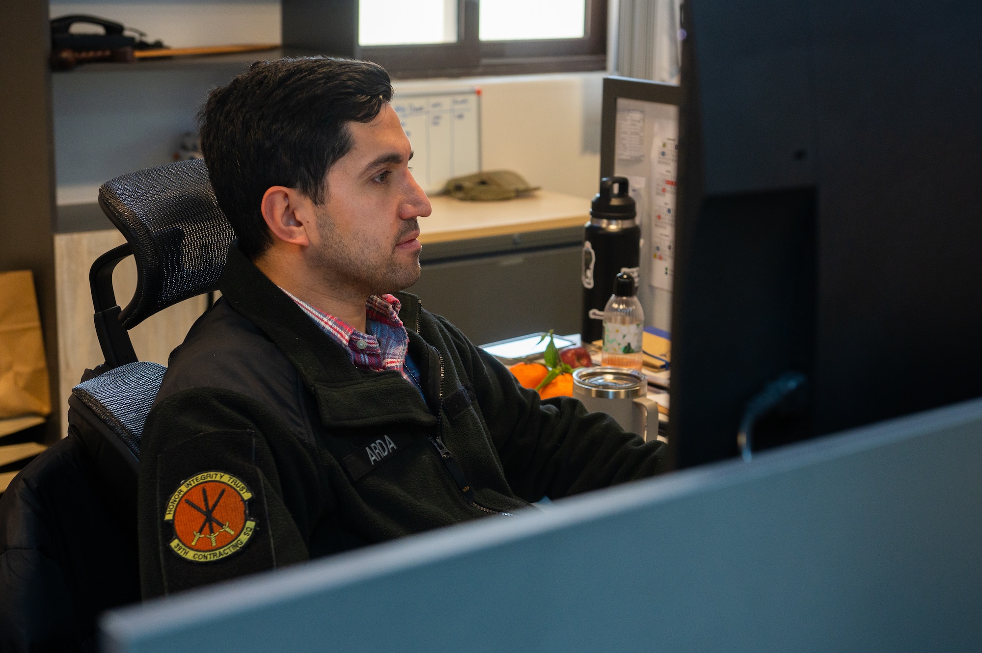 A man sits at a computer.