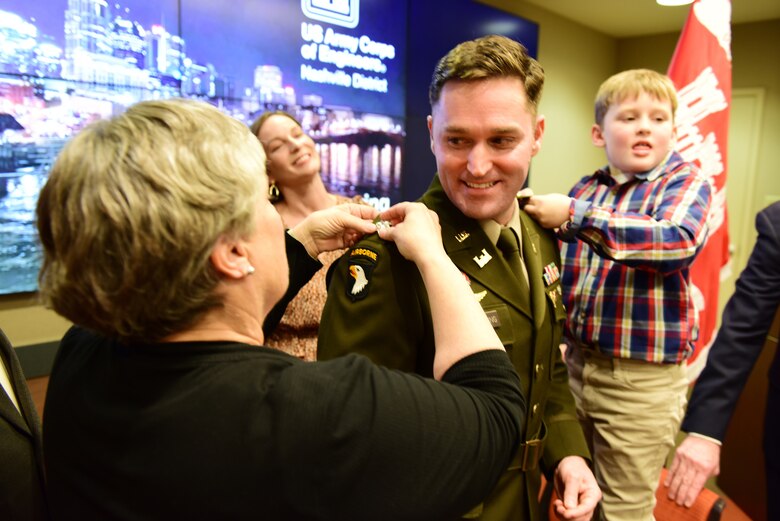 Todd A. Mainwaring’s mother Debbie and son Calvin pin on the new rank of lieutenant colonel during a promotion ceremony Feb. 2, 2024, at the U.S. Army Corps of Engineers Nashville District Headquarters in Nashville, Tennessee. His wife Darcy in the background also assisted with his promotion. Mainwaring is the Nashville District’s deputy commander. (USACE Photo by Lee Roberts)