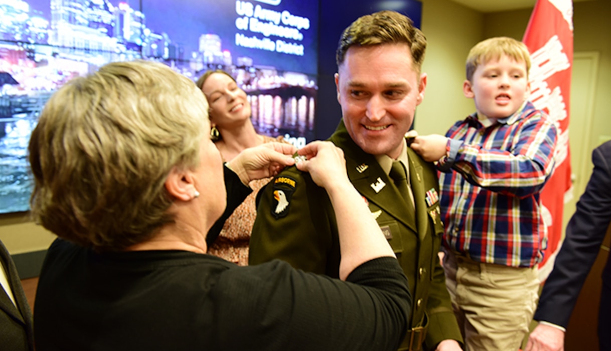 Todd A. Mainwaring’s mother Debbie and son Calvin pin on the new rank of lieutenant colonel during a promotion ceremony Feb. 2, 2024, at the U.S. Army Corps of Engineers Nashville District Headquarters in Nashville, Tennessee. His wife Darcy in the background also assisted with his promotion. Mainwaring is the Nashville District’s deputy commander. (USACE Photo by Lee Roberts)