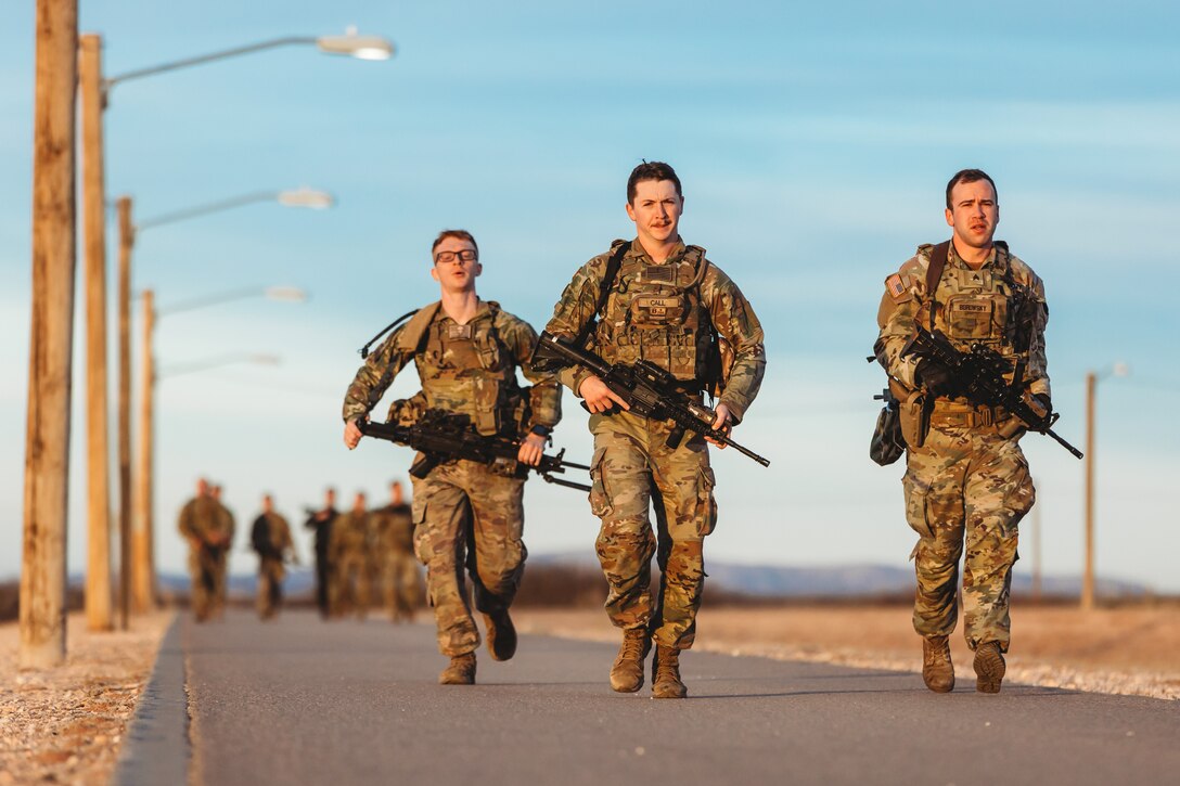 U.S. Soldiers with Charlie Company, 1st Battalion, 112th Infantry Regiment, 56th Stryker Brigade Combat Team complete a 3.6 mile run in combat gear during a physical training exercise at Camp McGregor, New Mexico, Jan. 14, 2024. They are training at Camp McGregor as they prepare for a deployment to the Horn of Africa. (U.S. Army photo by Staff Sgt. Jonathan Campbell)