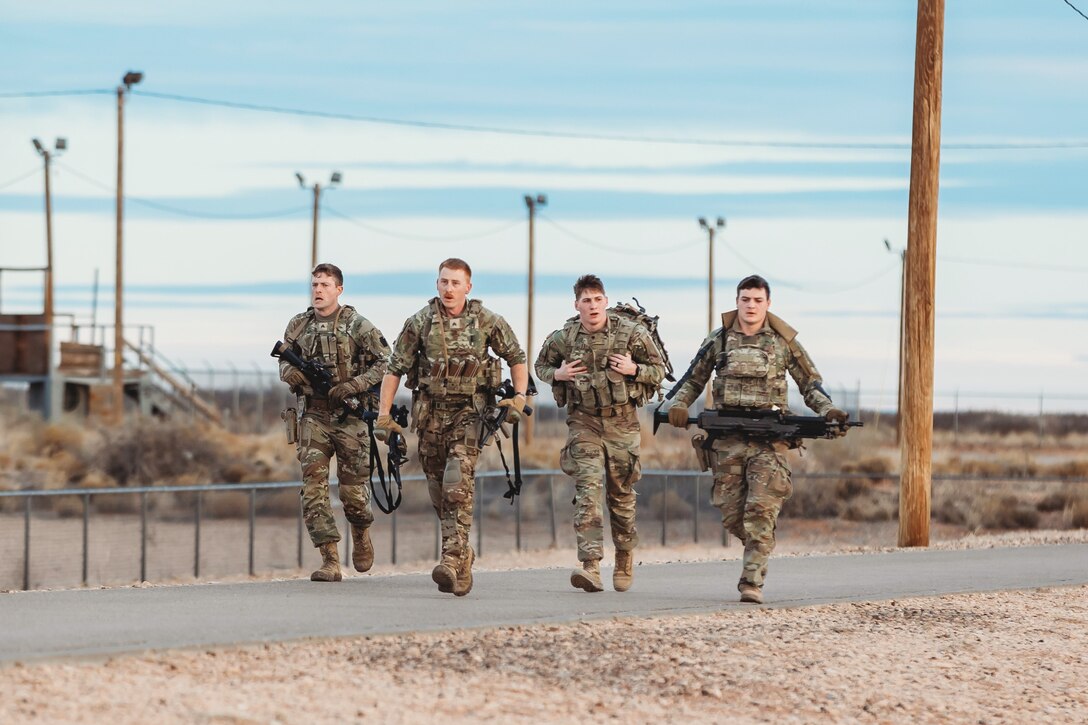 U.S. Soldiers with Charlie Company, 1st Battalion, 112th Infantry Regiment, 56th Stryker Brigade Combat Team complete a 3.6 mile run in combat gear during a physical training exercise at Camp McGregor, New Mexico, Jan. 14, 2024. They are training at Camp McGregor as they prepare for a deployment to the Horn of Africa. (U.S. Army photo by Staff Sgt. Jonathan Campbell)