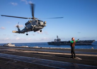 USS Theodore Roosevelt (CVN 71) conducts flight operations while underway with USS Carl Vinson (CVN 70) in the Philippine Sea.