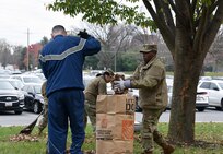 Lt. Col. Nikki Davis, right, deputy commander of the U.S. Army Medical Materiel Agency, helps collect leaves during a fall cleanup event Nov. 15, 2022, at Fort Detrick, Maryland.
