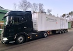 A truck and trailer in a parking lot.