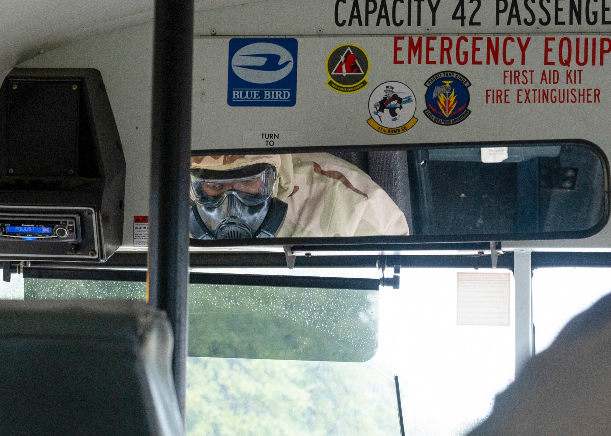 A U.S. Airman assigned to the 307th Logistics Readiness Squadron drives a passenger vehicle during a training exercise while wearing a mask.