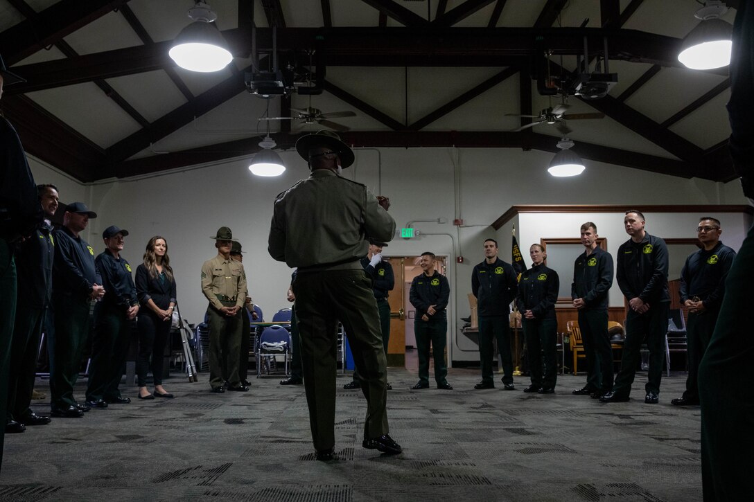 The Marine Corps Recruit Depot San Diego Regiment Color Guard, instructs the United States Forest Service Honor Guard on color guard techniques at MCRD San Diego, Feb. 1, 2024. The USFS Honor Guard visited the Depot to promote and reinforce the customs, history, and traditions of the Marine Corps. (U.S. Marine Corps photo by Lance Cpl. Sarah M. Grawcock)