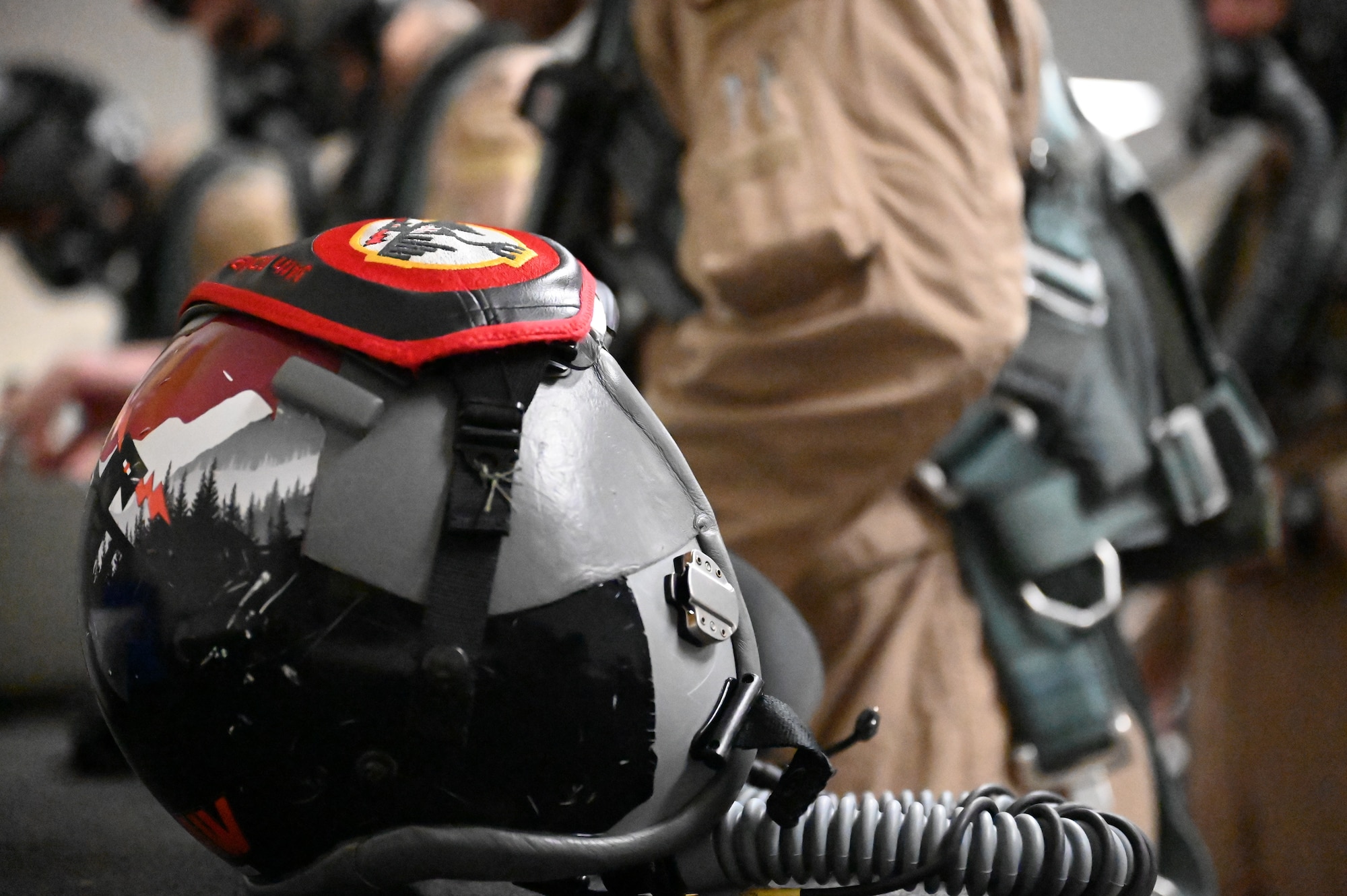 An aircrew helmet sits on a desk in the Aircrew Flight Equipment shop at Dyess Air Force Base, Texas, Feb. 1, 2024. Ellsworth Air Force Base B-1Bs recently launched from Dyess Air Force Base to support U.S. Central Command priorities, validating the United States Air Force capability to provide precision, long-range strike anytime, anywhere. (U.S. Air Force photo by Staff Sgt. Holly Cook)