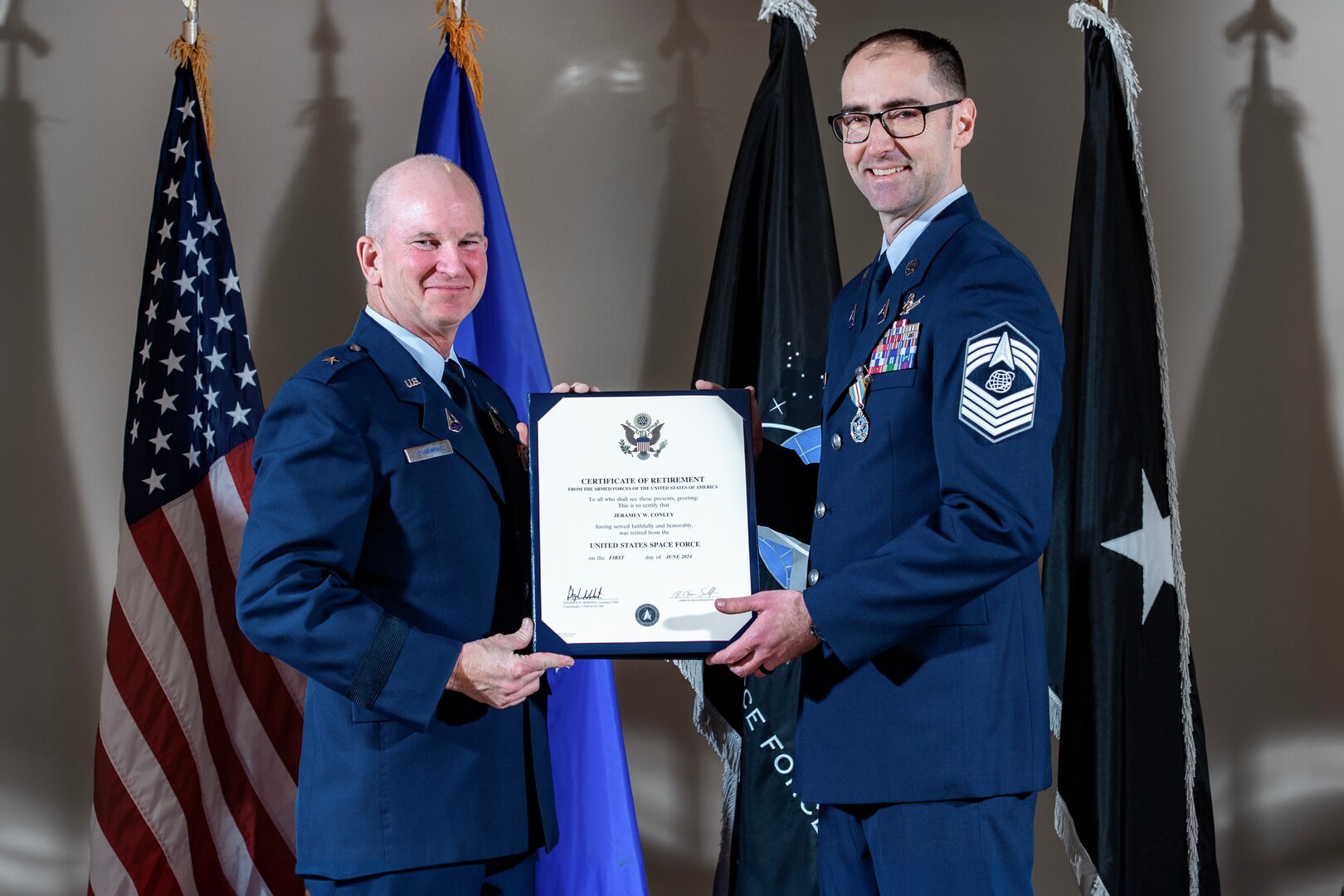 two service members hold certificate