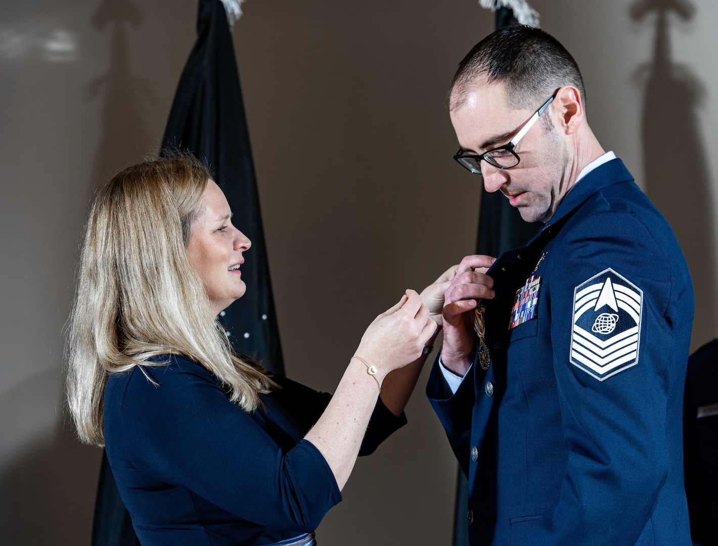 wife pins service member's lapel