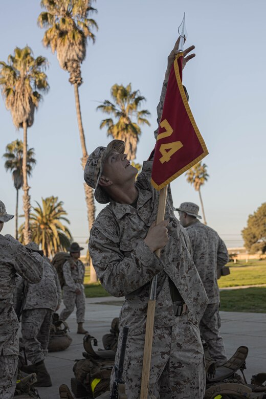 U.S. Marine Corps Recruit Benedict Stur, with Delta Company, 1st Recruit Training Battalion, takes the pike off the platoon guidon after completing an 8-kilometer hike on Marine Corps Base Camp Pendleton, California, Jan. 30, 2024. The purpose of the hike is to condition recruits to the rigorous terrain on Camp Pendleton and prepare them for their 13-kilometer hike and culminating event - the Crucible. Stur was recruited out of RSS Denver Metro South. (U.S. Marine Corps photo by Lance Cpl. Alexandra M. Earl)