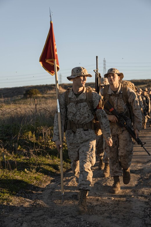 U.S. Marine Corps Recruit Benedict Stur, with Delta Company, 1st Recruit Training Battalion, conducts a 8-kilometer hike on Marine Corps Base Camp Pendleton, California, Jan. 30, 2024. The purpose of the hike is to condition recruits to the rigorous terrain on Camp Pendleton and prepare them for their 13-kilometer hike and culminating event - the Crucible. Stur was recruited out of RSS Denver Metro South. (U.S. Marine Corps photo by Lance Cpl. Alexandra M. Earl)