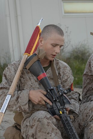 U.S. Marine Corps Recruit Benedict Stur, with Delta Company, 1st Recruit Training Battalion, takes a pause at the halfway mark of a 8-kilometer hike on Marine Corps Base Camp Pendleton, California, Jan. 30, 2024. The purpose of the hike is to condition recruits to the rigorous terrain on Camp Pendleton and prepare them for the 13-kilometer hike and culminating event - the Crucible. Stur was recruited out of RSS Denver Metro South. (U.S. Marine Corps photo by Lance Cpl. Alexandra M. Earl)